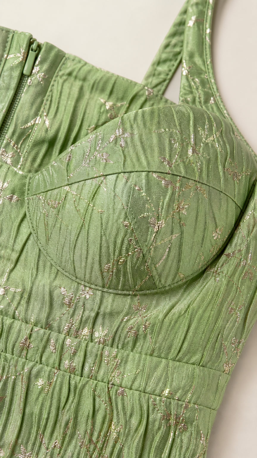 Close-up detail of sweetheart bustier cups and metallic pleated fabric in sage green