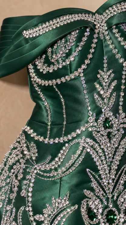 Close-up of crystal beadwork and fringe detail on satin gown