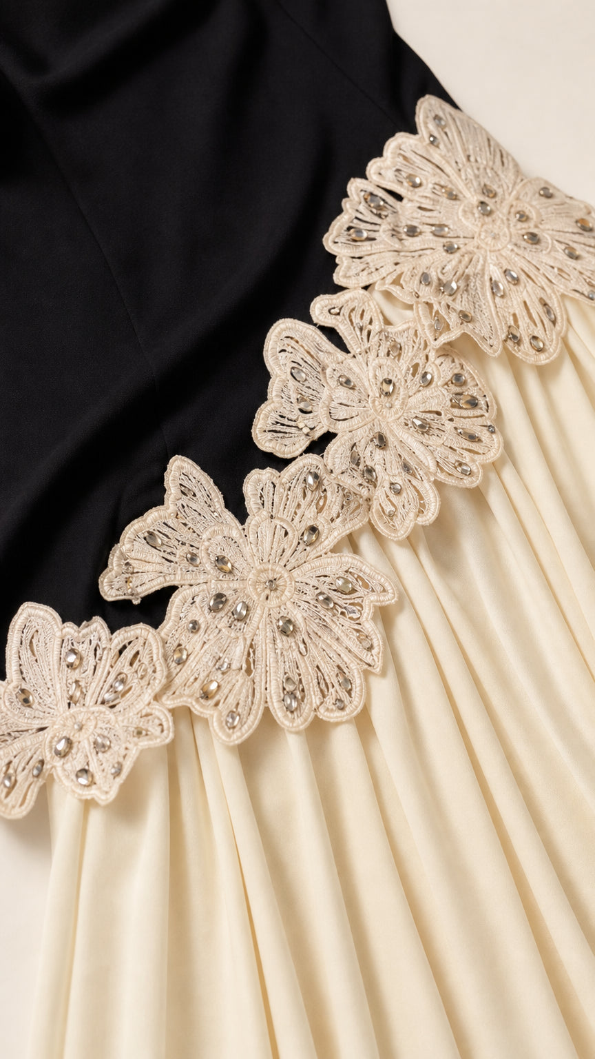 Close-up detail of the beaded floral lace appliqué on the dress
