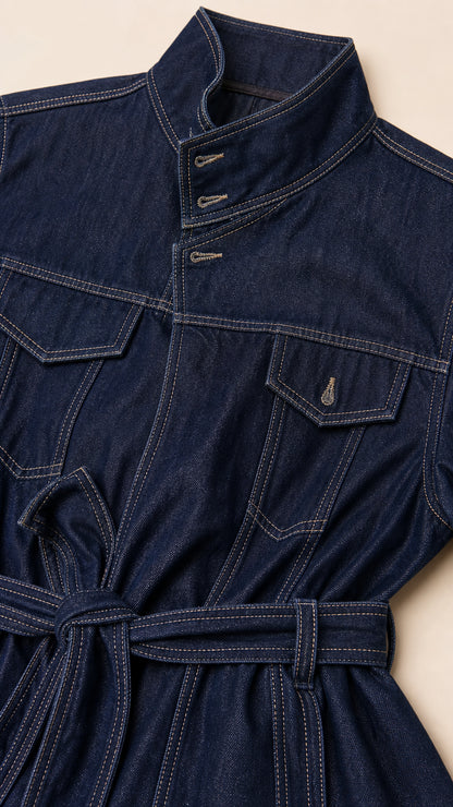 Close-up of dark denim jacket collar, buttons, and belt details