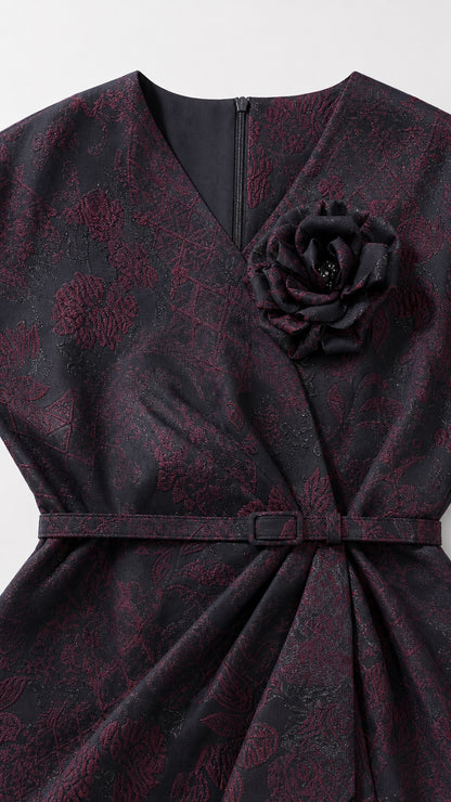 Close-up of V-neckline, belt, and detachable rose brooch detail