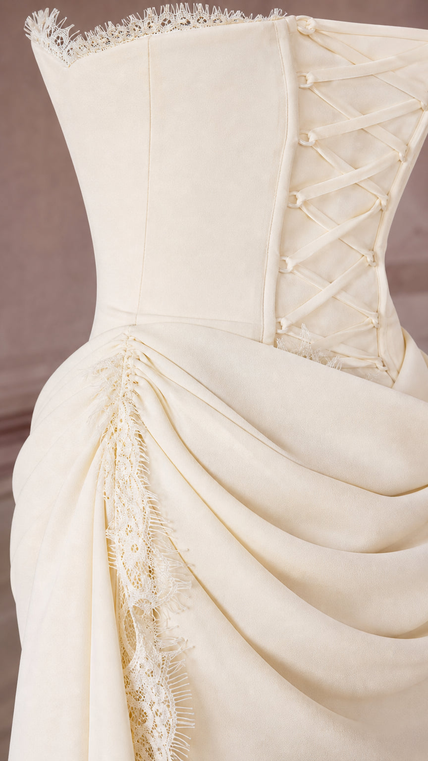 Close-up of ivory dress bodice detailing boning, lace-up accents, and eyelash lace trim