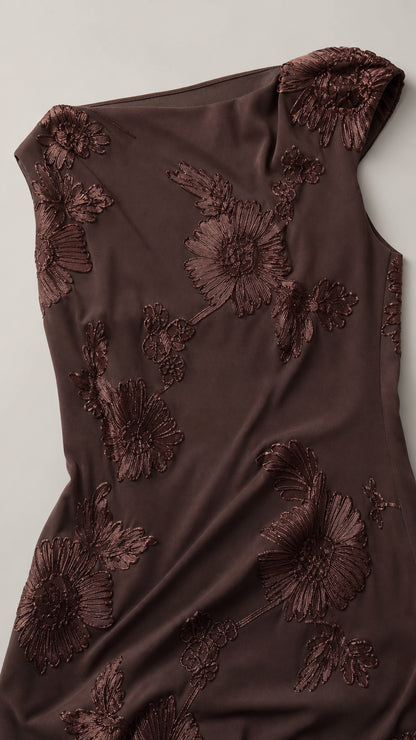 Close-up of brown dress fabric and floral embroidery detail