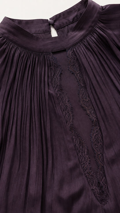 Close up of high neckline and lace trim on plum dress