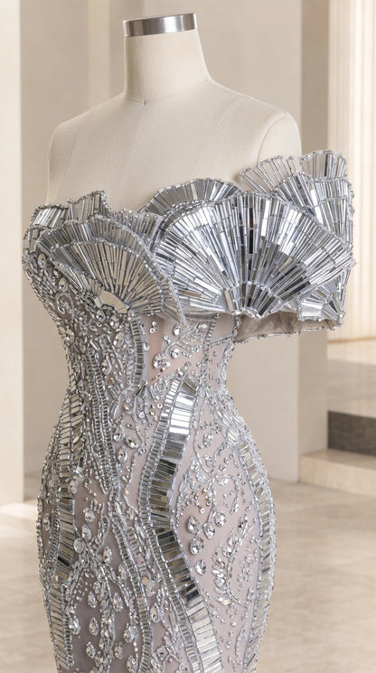 Close-up mannequin detail of silver pleated fan-shaped neckline and beaded bodice