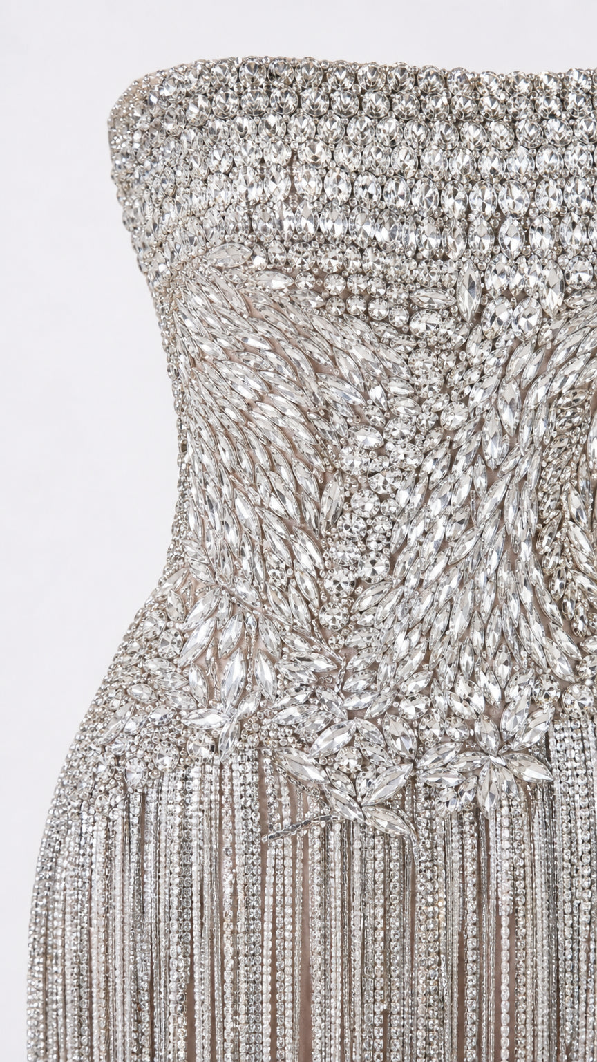 Close-up view of intricate crystal bodice embellishment and fringe transition
