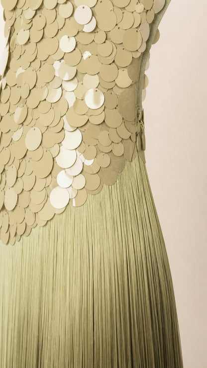 Close-up detail of green disc sequin bodice and flowing fine fringe tassels
