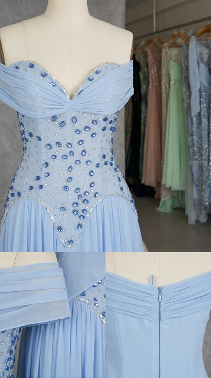 Close-up detail of rhinestone embellishments and back zipper on light blue gown