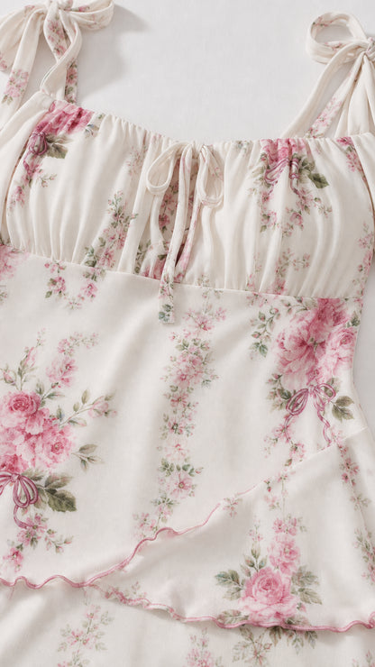 Close-up detail of the gathered bodice and tie straps on ivory floral dress