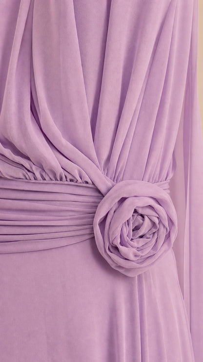 Close-up detail of pleated waistband and 3D floral rosette on lavender dress