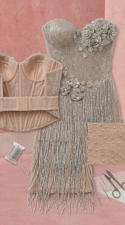 Close-up detail of inner corset boning, beaded fringe, and 3D floral appliques