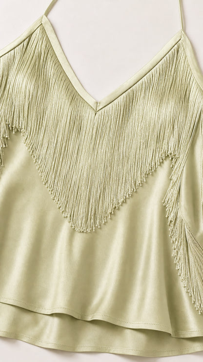 Close-up detail of sage green fringe bodice and satin hem