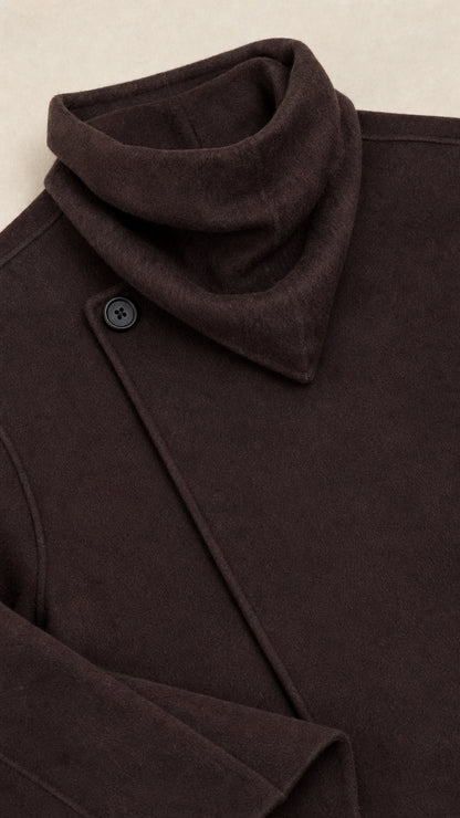 Close-up detail of the cowl collar and single button closure on dark brown jacket