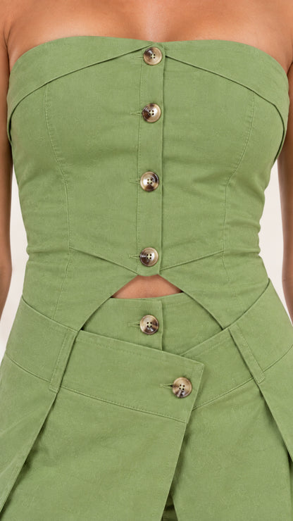 Close-up detail of sage green jumpsuit bodice with buttons and waist cutout