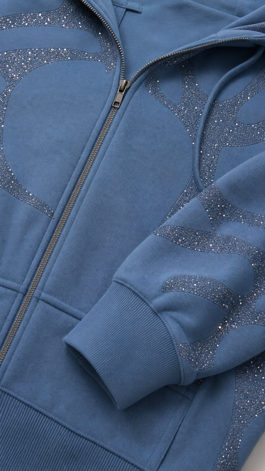Close-up detail of Slate Blue cropped hoodie showing metal zipper and glitter rhinestone pattern