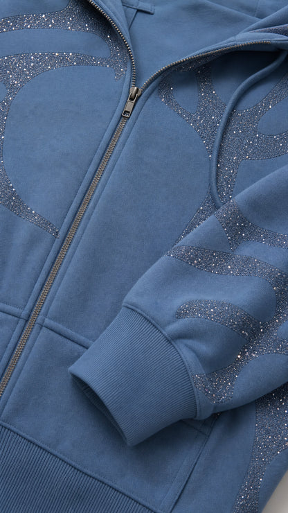 Close-up detail of Slate Blue cropped hoodie showing metal zipper and glitter rhinestone pattern