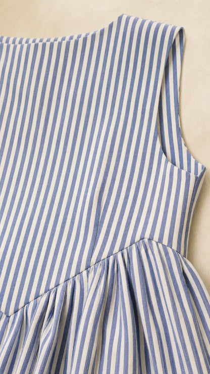 Close-up of fabric and dropped waist detail on blue striped dress