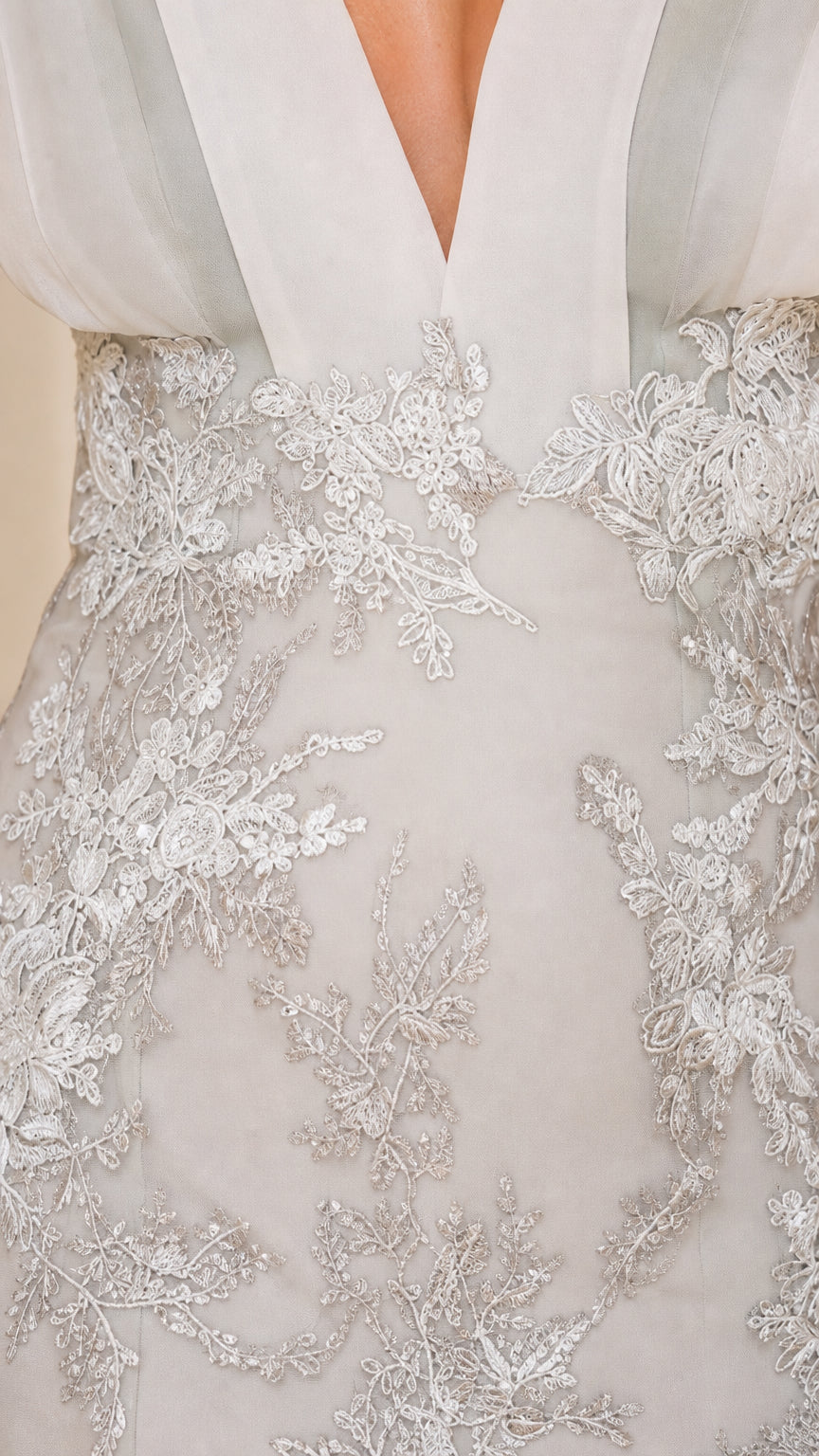 Close-up detail of Silver floral lace embroidery and pleated plunge bodice