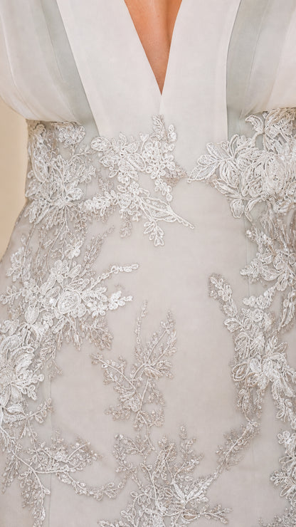 Close-up detail of Silver floral lace embroidery and pleated plunge bodice