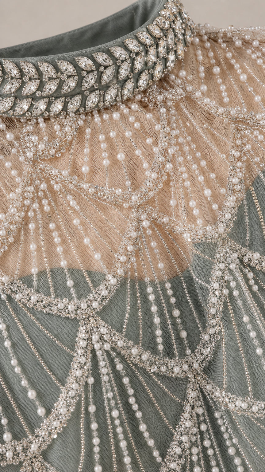 Close-up detail of jeweled crystal collar and delicate beaded mesh capelet
