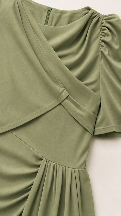 Close-up detail of the asymmetric draped overlay and ruched shoulder