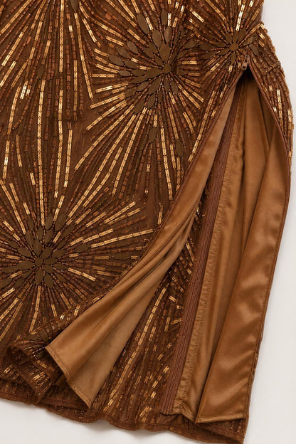 Close-up detail of the beadwork and side slit on bronze gown