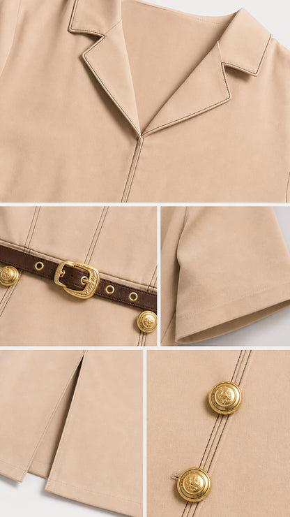 Close-up details of notch lapel collar, belt buckle, short sleeve cuff, and gold crest buttons