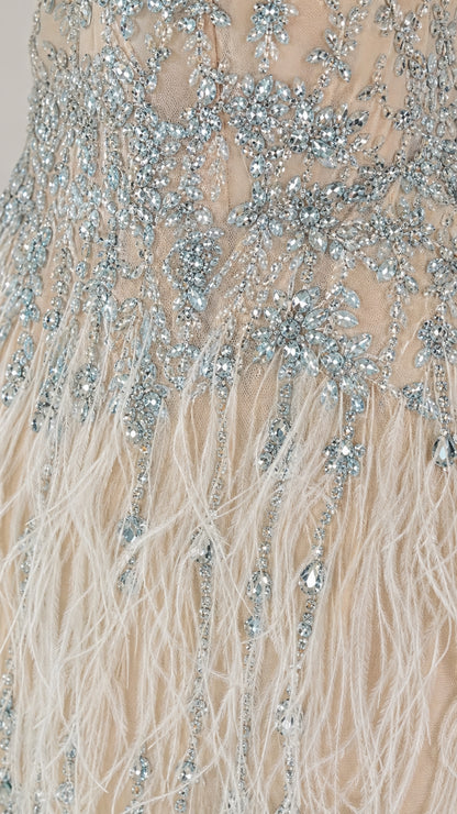Close up of crystal beadwork and feather detail on dress