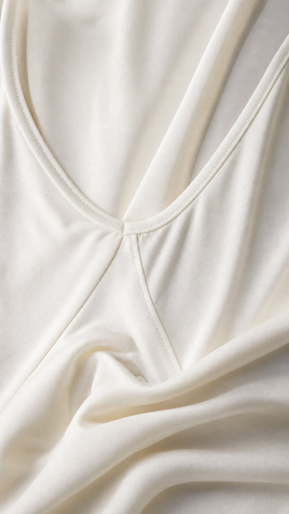 Close-up detail of smooth white stretch knit fabric and neat neckline stitching
