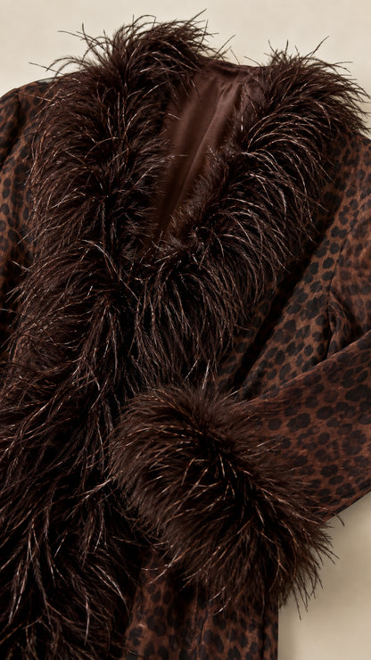 Close-up detail shot of the brown leopard fabric texture, collar trim, and inner lining