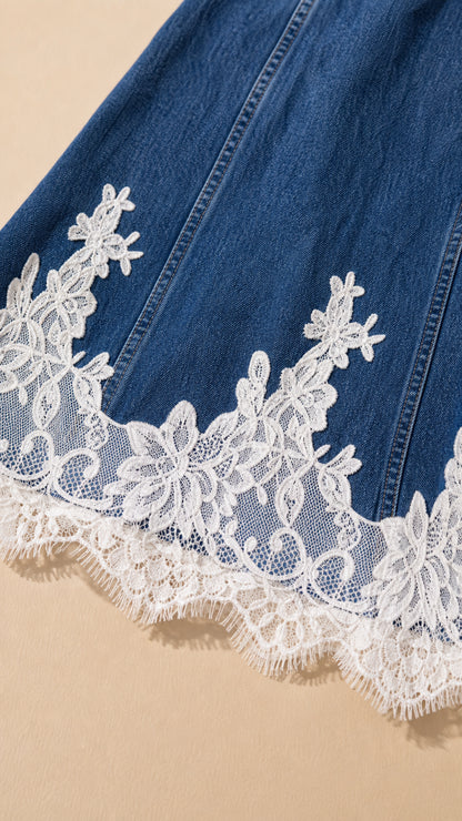 Close-up detail of white scalloped floral lace trim along the denim hemline