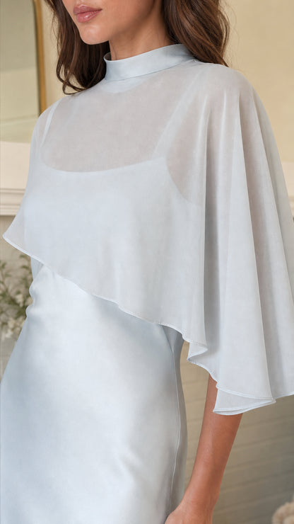 Close-up detail of sheer cape overlay and mock neck in Light Blue