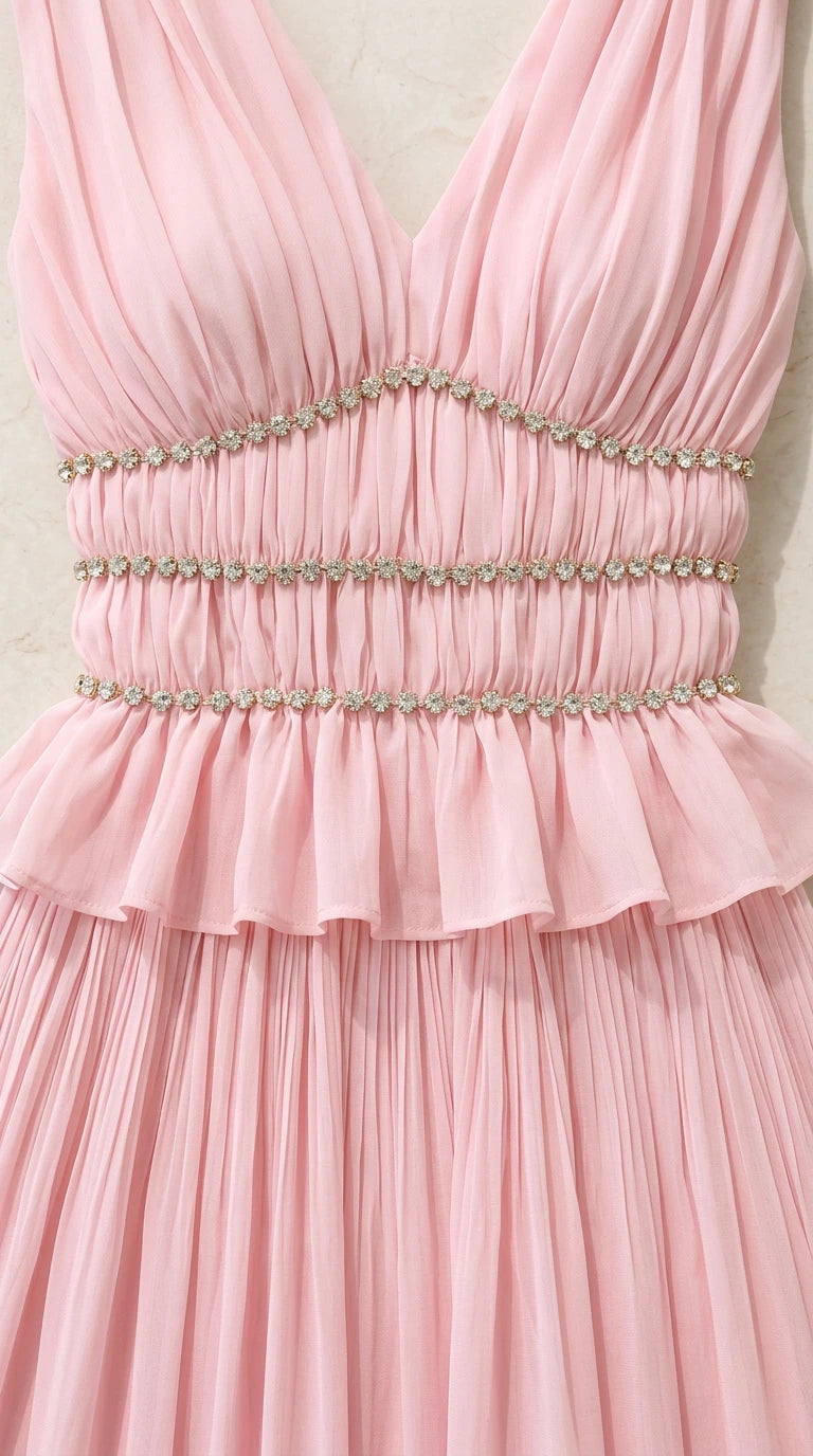 Close-up detail of pink bodice showing ruched beaded waist and ruffle trim