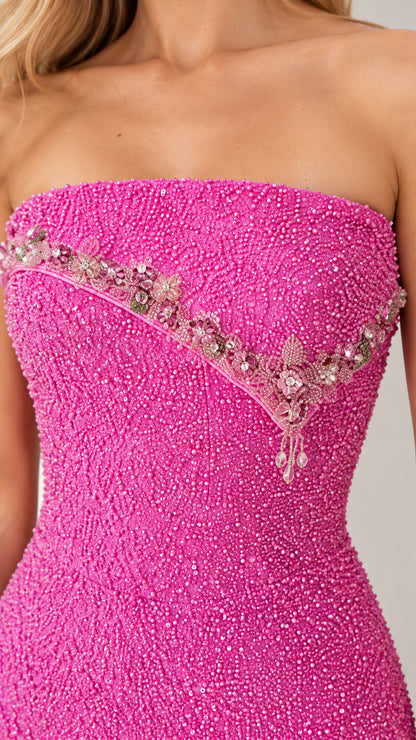 Close-up detail of fuchsia beaded bodice with crystal floral embellishment