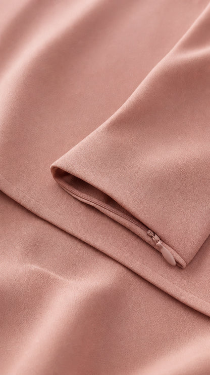 Close-up of smooth pink fabric and zipper detail