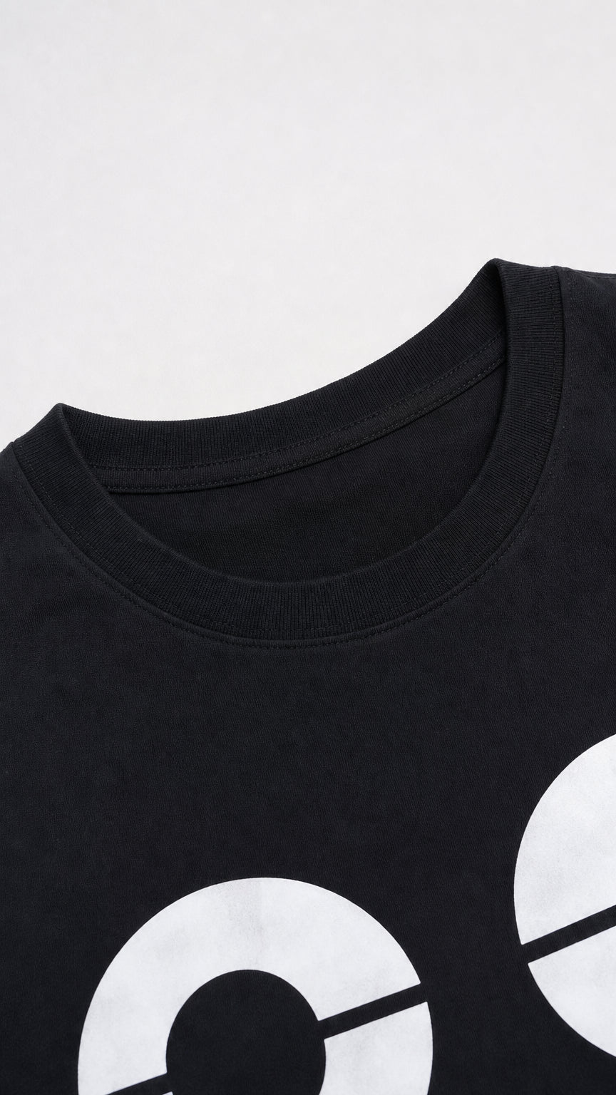 Close-up of crew neckline and '88' graphic print detail on black knit fabric