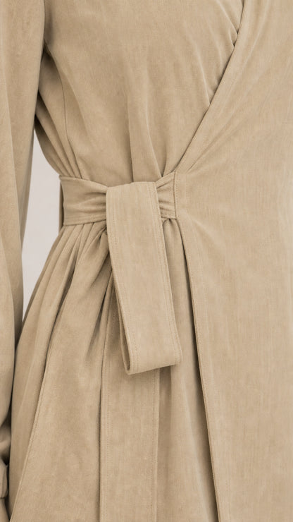 Close-up detail of the wrap-tie waist and lapel collar on khaki set