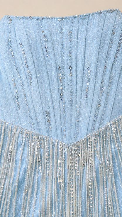 Close-up detail of shimmering beads and corset boning on light blue gown
