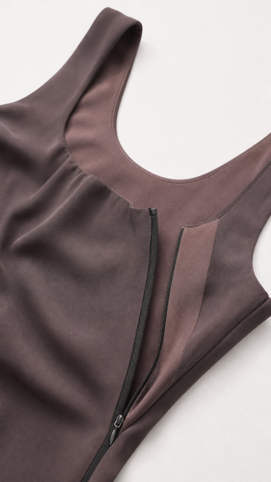 Close-up detail of scoop neckline and hidden side zipper on draped bodice