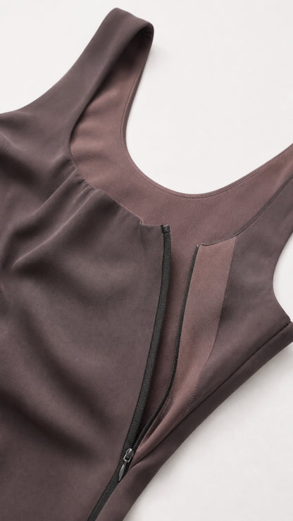 Close-up detail of scoop neckline and hidden side zipper on draped bodice