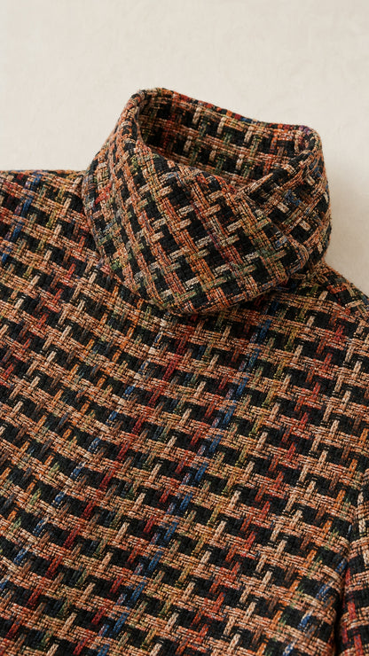 Close-up detail of high funnel collar in multi-color woven textured tweed fabric