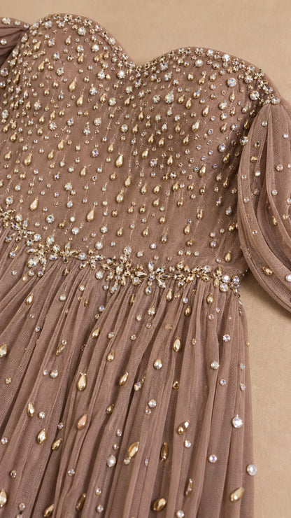 Close-up detail of sparkling rhinestone embellishments on pleated tulle bodice