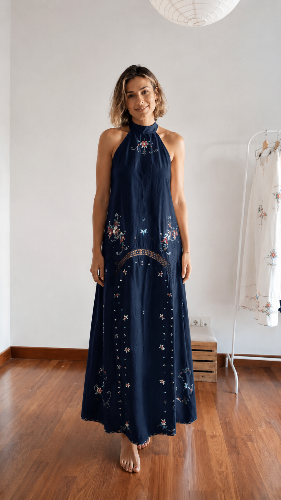 Front view of navy embroidered halter maxi dress