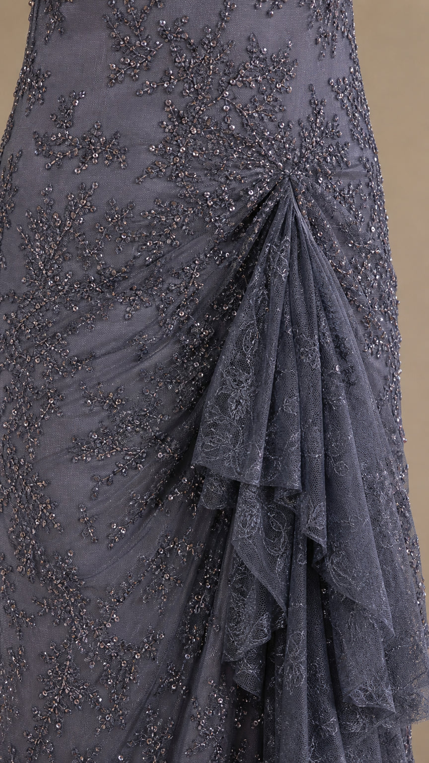 Close-up of intricate sequin and bead embroidery with side ruffle