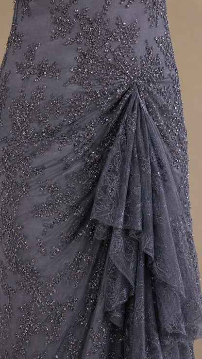 Close-up of intricate sequin and bead embroidery with side ruffle
