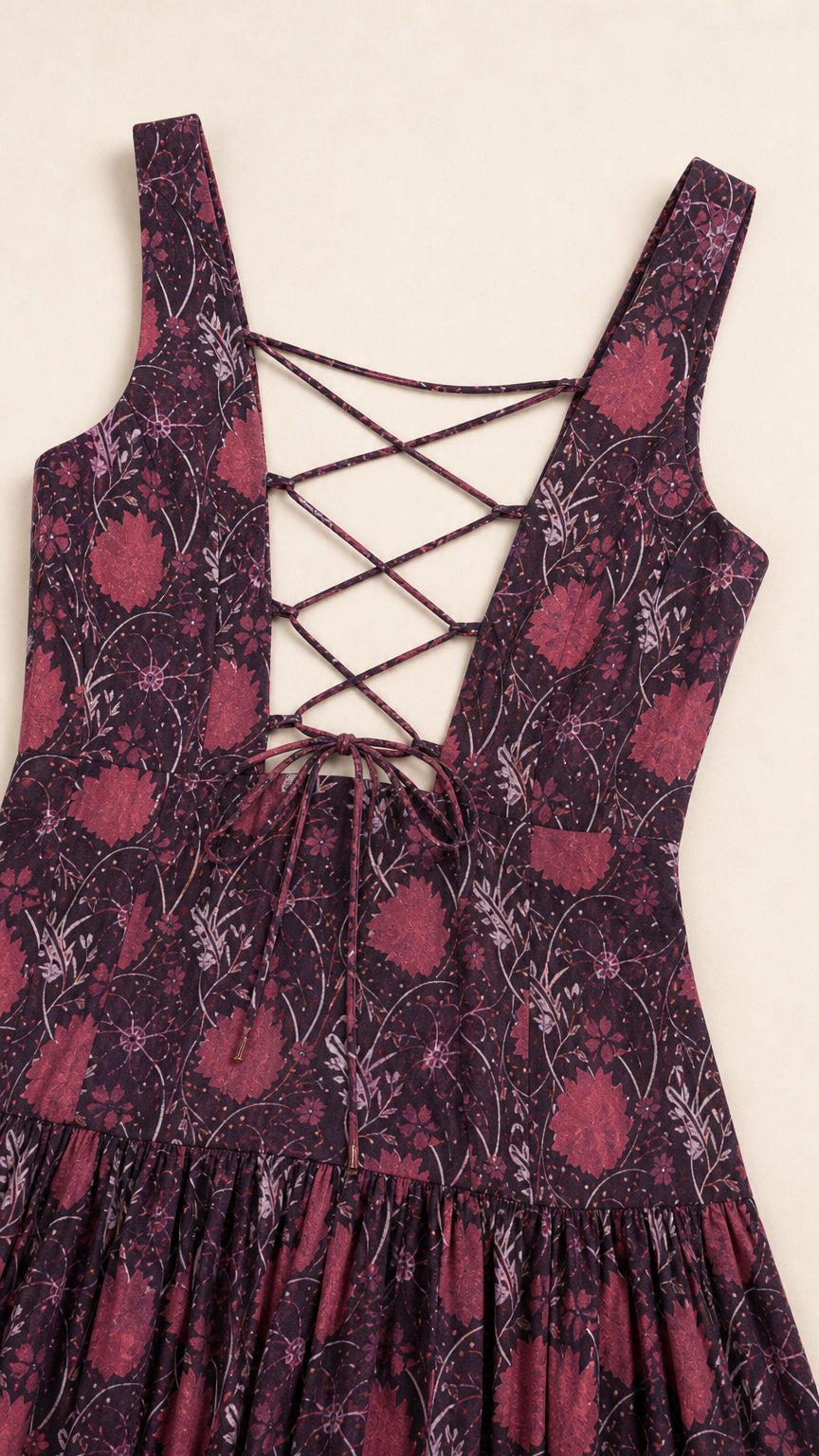 Close-up of the lace-up back and fabric pattern on the burgundy maxi dress