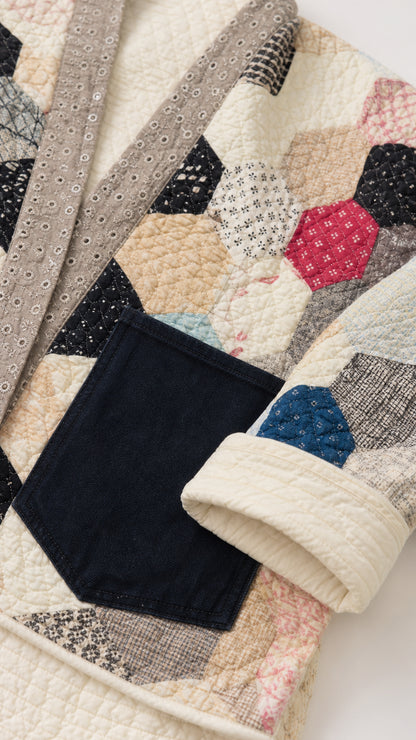 Close-up detail of textured hexagon quilt pattern and pocket