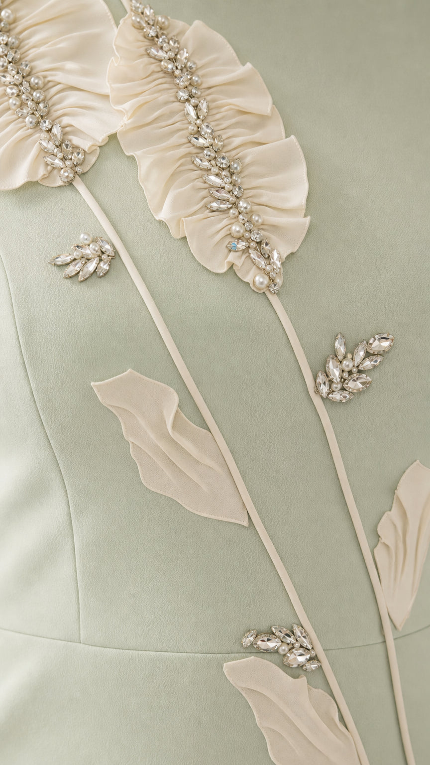 Close up of crystal and ruffled floral vine applique detail