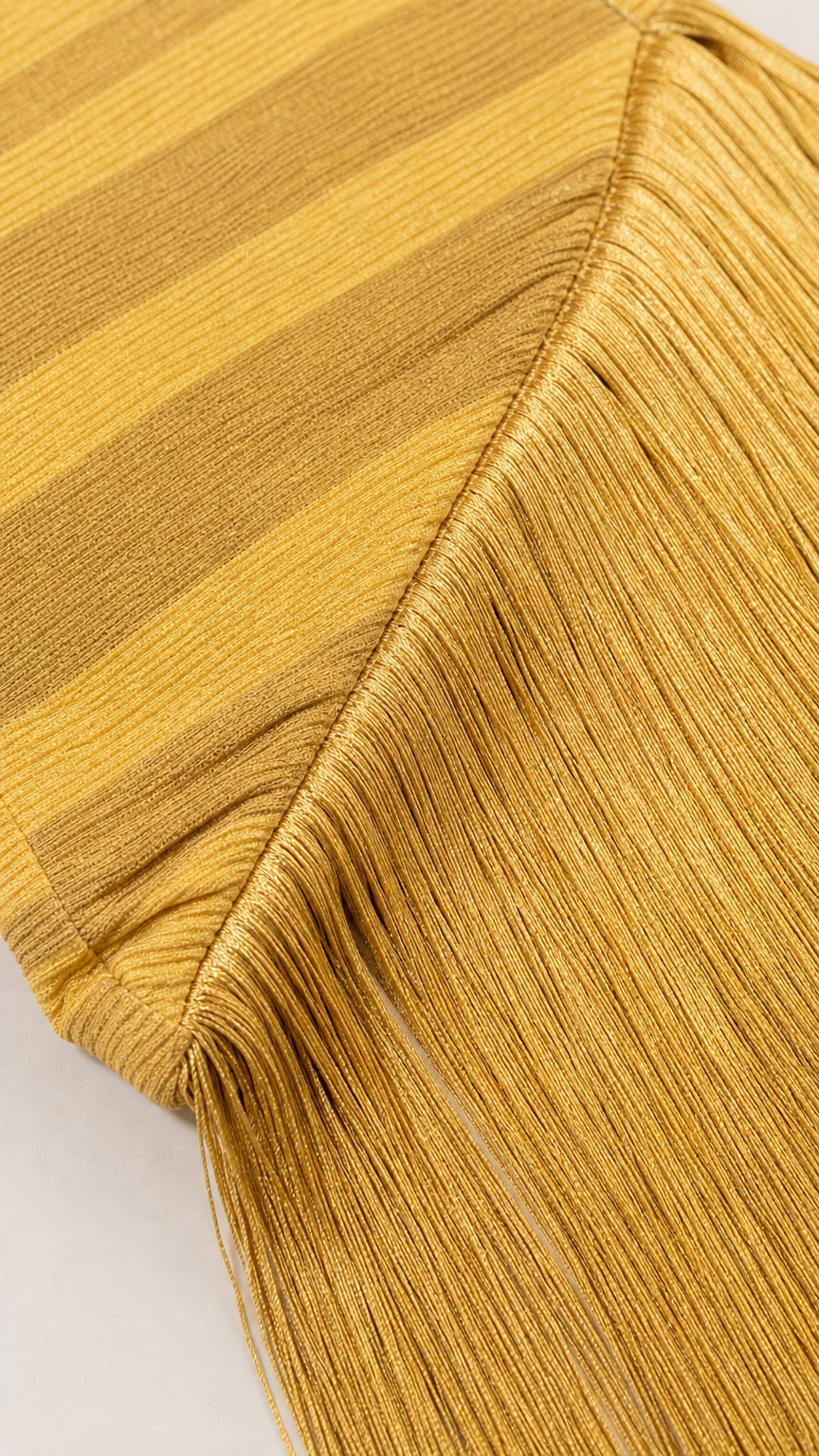 Close-up detail of textured ribbed fabric and dense fringe hem stitching