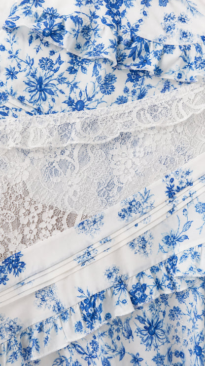 Close-up detail of floral print fabric and sheer lace panels